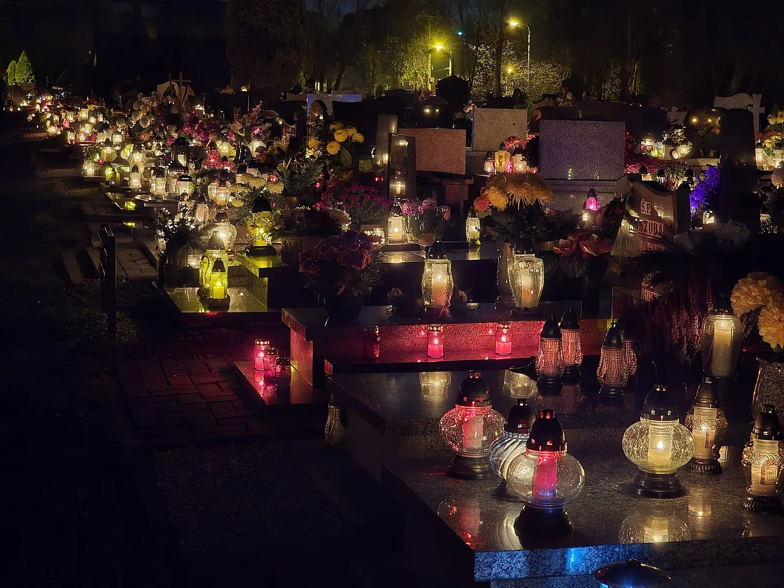 Graves in a Polish cemetery covered with candles on All Saints' Day